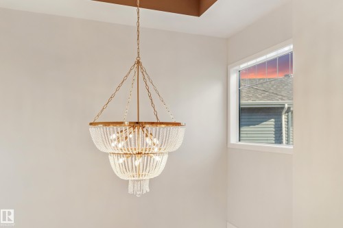 Tiered chandelier with gold-tone hardware and clear beaded accents - 4015 39 Street, Beaumont, AB - Indoor Photo Showing Other Room