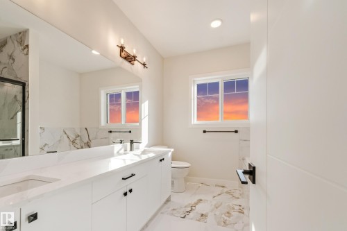 Dual vanity with undermount sinks, white cabinetry, and quartz countertops - 4015 39 Street, Beaumont, AB - Indoor Photo Showing Bathroom