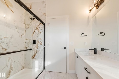 Tiled shower with a black-framed glass enclosure - 4015 39 Street, Beaumont, AB - Indoor Photo Showing Bathroom