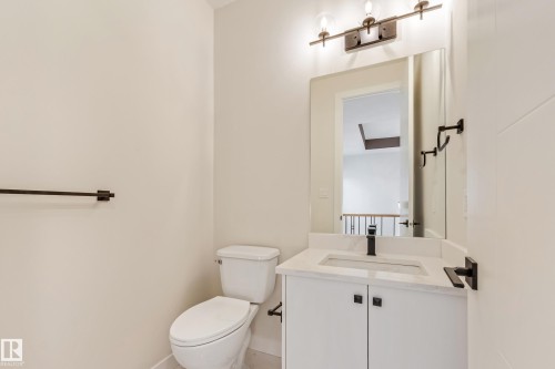 Bathroom featuring a white vanity with a light-colored countertop, an undermount sink, and a matte black faucet - 4015 39 Street, Beaumont, AB - Indoor Photo Showing Bathroom