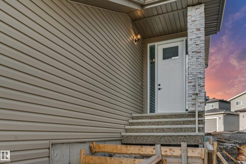 Entryway with a white door featuring a frosted glass insert, flanked by a full-length sidelight - 4015 39 Street, Beaumont, AB - Outdoor