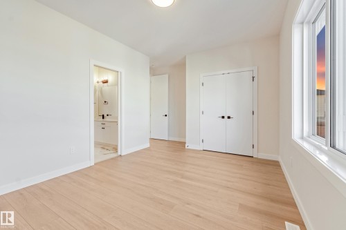 Spacious room featuring light wood-finish flooring, white walls, and a recessed ceiling light - 4015 39 Street, Beaumont, AB - Indoor Photo Showing Other Room