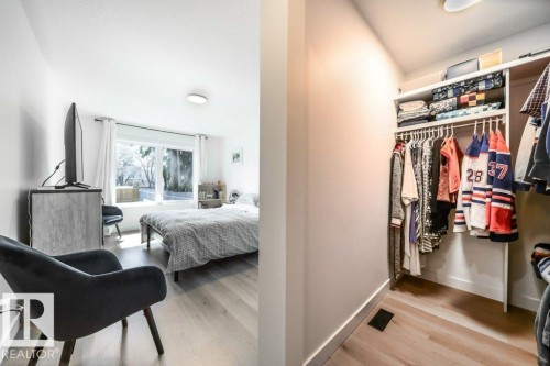 Bright room featuring wood-finish flooring and a large window - 11303 111 Avenue, Edmonton, AB - Indoor