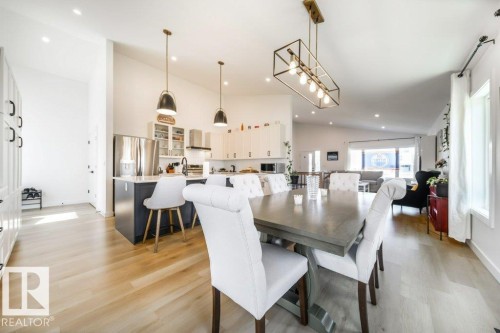 Open-concept living space featuring wood-finish flooring and vaulted ceilings - 11303 111 Avenue, Edmonton, AB - Indoor Photo Showing Dining Room