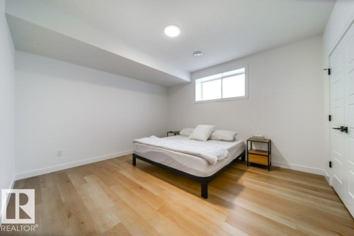 Room with light wood-finish flooring, white walls, and a recessed ceiling light fixture - 11303 111 Avenue, Edmonton, AB - Indoor Photo Showing Bedroom