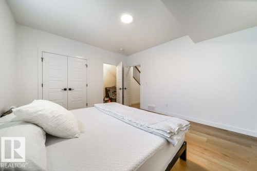 Interior room featuring wood-finish flooring and white baseboards - 11303 111 Avenue, Edmonton, AB - Indoor Photo Showing Bedroom