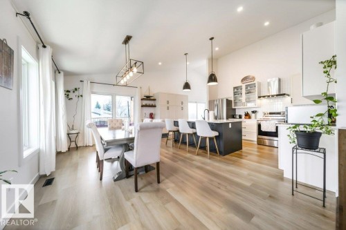 Open-concept living space with wood-finish flooring extending throughout - 11303 111 Avenue, Edmonton, AB - Indoor Photo Showing Dining Room