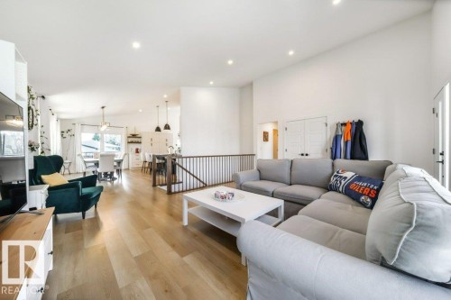 Open-concept living space featuring wood-finish flooring, recessed lighting, and a white color palette - 11303 111 Avenue, Edmonton, AB - Indoor Photo Showing Living Room