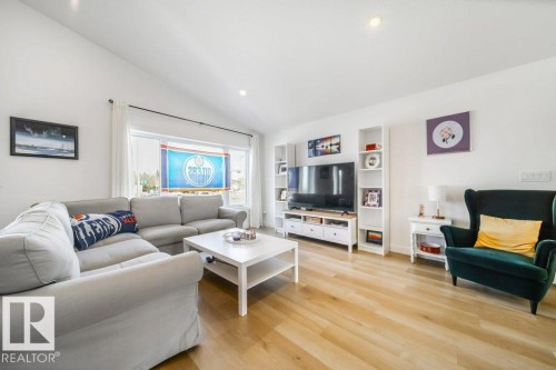 Living area featuring a vaulted ceiling and light wood-finish flooring - 11303 111 Avenue, Edmonton, AB - Indoor Photo Showing Living Room