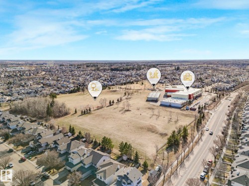 Aerial perspective showcasing a residential area with varied housing structures - 322 1520 Hammond Gate Nw, Edmonton, AB - Outdoor With View