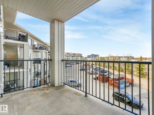Private balcony with a concrete floor and black metal railing - 322 1520 Hammond Gate Nw, Edmonton, AB - Outdoor With Balcony With Exterior