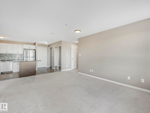 Open concept living space with light neutral carpeting - 322 1520 Hammond Gate Nw, Edmonton, AB - Indoor