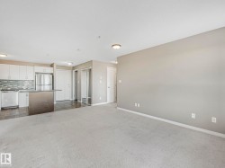 Open concept living space with light neutral carpeting - 