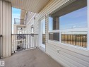Private balcony featuring a concrete floor, black metal railings, and light-colored siding - 322 1520 Hammond Gate Nw, Edmonton, AB  - Outdoor With Balcony With Exterior 