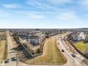 Expansive aerial perspective showcasing a neighborhood with a mix of multi-family and single-family residential properties - 322 1520 Hammond Gate Nw, Edmonton, AB  - Outdoor With View 