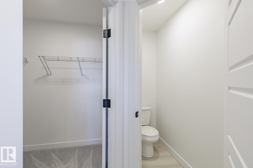 Well-appointed closet with wire shelving system and patterned carpeting - 6275 180 Avenue Nw, Edmonton, AB - Indoor