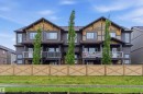 Modern townhome exterior featuring multi-toned siding and cedar shake accents - 36 1005 Graydon Hill Boulevard, Edmonton, AB 