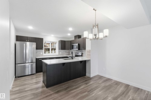 Open-concept kitchen and dining area featuring wood-finish flooring - 36 1005 Graydon Hill Boulevard, Edmonton, AB 