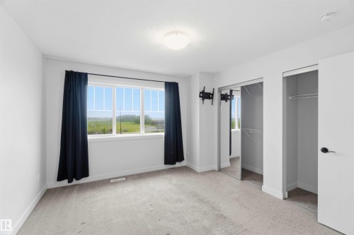 Room with light gray carpet, white walls, and a multi-pane window - 36 1005 Graydon Hill Boulevard, Edmonton, AB 