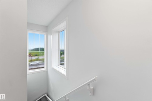 White interior walls with two windows featuring white trim and sills - 36 1005 Graydon Hill Boulevard, Edmonton, AB 