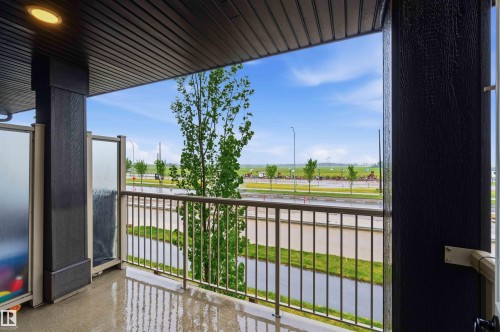 Covered balcony featuring a concrete surface, metal railings, and privacy screens - 36 1005 Graydon Hill Boulevard, Edmonton, AB 