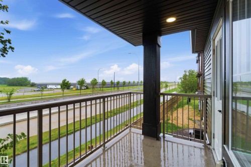 Private balcony featuring a dark wood-finish ceiling, integrated recessed lighting, and a metal railing - 36 1005 Graydon Hill Boulevard, Edmonton, AB 