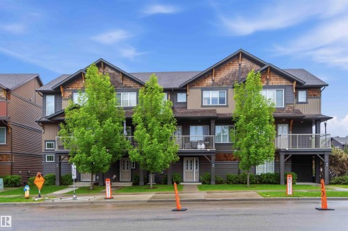 Contemporary multi-story exterior featuring a grey shingle roof and a mix of tan siding, dark brown siding, and shake shingles - 36 1005 Graydon Hill Boulevard, Edmonton, AB 