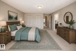 Spacious bedroom featuring light neutral wall paint, plush carpet flooring, and white bi-fold closet doors - 