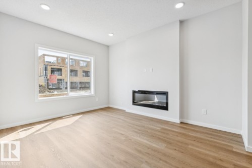61 Gambel Loop, Spruce Grove, AB - Indoor Photo Showing Living Room With Fireplace