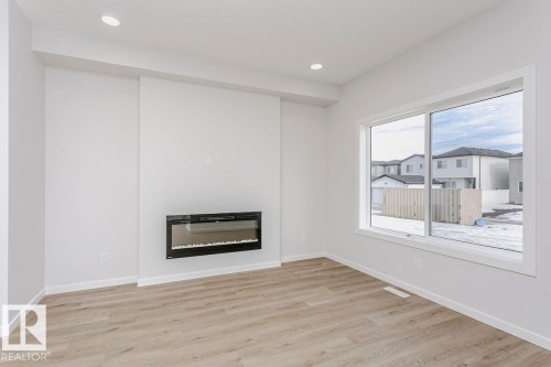61 Gambel Loop, Spruce Grove, AB - Indoor Photo Showing Living Room With Fireplace