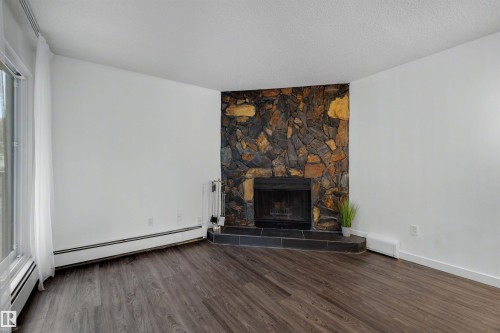 103 10138 116 Street, Edmonton, AB - Indoor Photo Showing Living Room With Fireplace