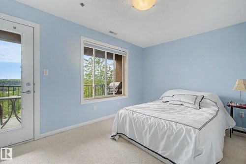 Room featuring light blue walls and carpeting - 303 530 Hooke Road, Edmonton, AB - Indoor Photo Showing Bedroom