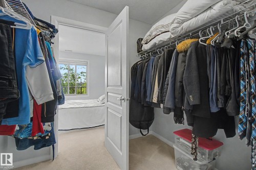 Walk-in closet with wire shelving and hanging rods - 303 530 Hooke Road, Edmonton, AB - Indoor With Storage