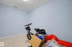 Room featuring light blue walls, neutral carpet, and a ceiling-mounted light fixture - 