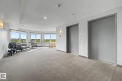 Elevator lobby featuring dual elevators, recessed lighting, and a carpeted floor - 
