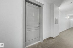 Entry door with paneled detailing, chrome hardware, and a number plate - 