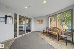 Entry foyer featuring automatic glass doors, recessed lighting, large windows, and tile flooring - 