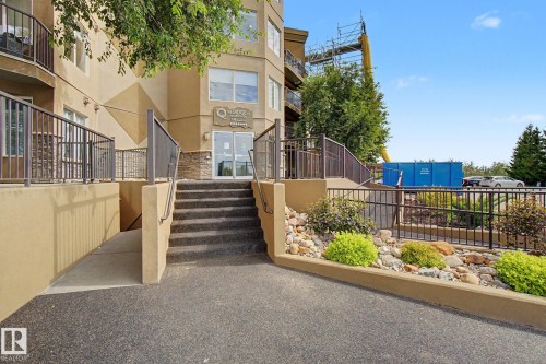 Building entrance featuring stone accents, a multi-story facade, and a prominent "The Ridge" sign - 303 530 Hooke Road, Edmonton, AB - Outdoor