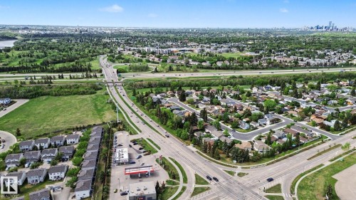Aerial perspective showcasing an established residential area with mature trees and diverse housing styles - 303 530 Hooke Road, Edmonton, AB - Outdoor With View