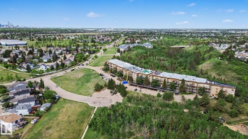 Aerial perspective showcasing a multi-story residential building with private balconies - 303 530 Hooke Road, Edmonton, AB - Outdoor With View