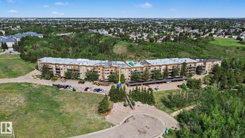 Multi-story residential building with light-colored exterior and multiple balconies - 303 530 Hooke Road, Edmonton, AB - Outdoor With View