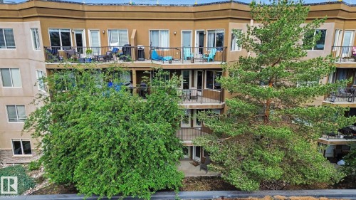 Multi-story building exterior with multiple private balconies featuring dark metal railings - 303 530 Hooke Road, Edmonton, AB - Outdoor With Deck Patio Veranda