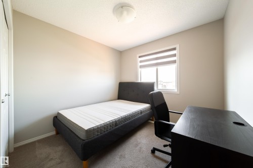 Neutral wall paint, window with blinds, carpeted flooring, and a flush mount ceiling light - 3038 Checknita Way Sw, Edmonton, AB 