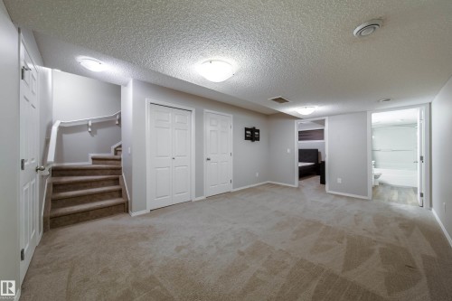Expansive carpeted area featuring light gray wall tones - 3038 Checknita Way Sw, Edmonton, AB 