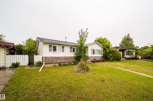 Two-story residence featuring white siding and a stone facade - 8512 142A Avenue, Edmonton, AB 