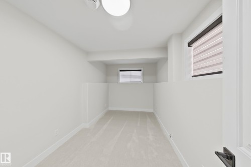 Bright interior space featuring light-colored carpeting, white wall paint, and white trim - 6144 166 Avenue, Edmonton, AB 