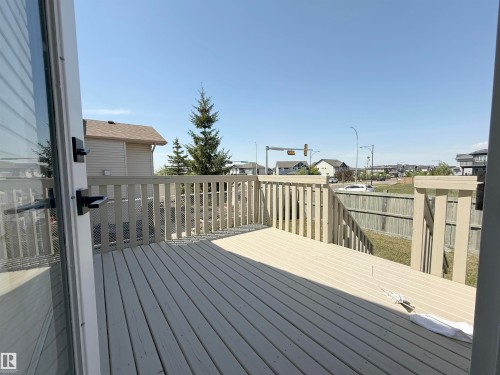 Spacious outdoor deck with light-toned wood-finish flooring and matching railing - 6144 166 Avenue, Edmonton, AB 