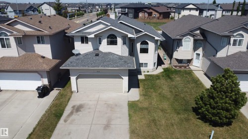 Light-colored siding exterior with contrasting roof, arched window accents, and a two-car garage - 6144 166 Avenue, Edmonton, AB 
