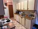 Kitchen featuring wood-finish countertops and light cabinetry with round hardware - 304 10604 110 Avenue, Edmonton, AB 