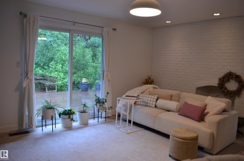 Sliding glass doors open to an outdoor deck - 68 Marlboro Road, Edmonton, AB 